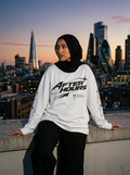 Model in a hijab wearing the After Hours Orbit Long Sleeve Tee on a London rooftop at dusk