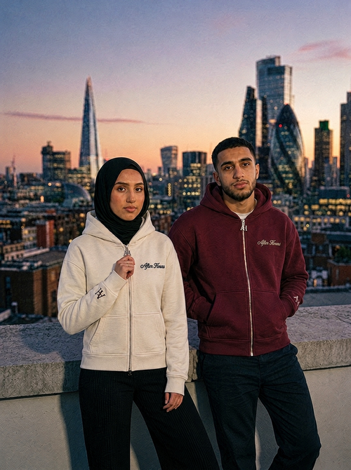 Models wearing the After Hours maroon and cream Signature Zip Hoodies on a London rooftop at dusk